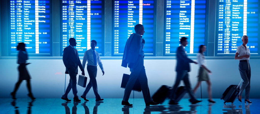 Future of business travel: business travellers walk through an airport